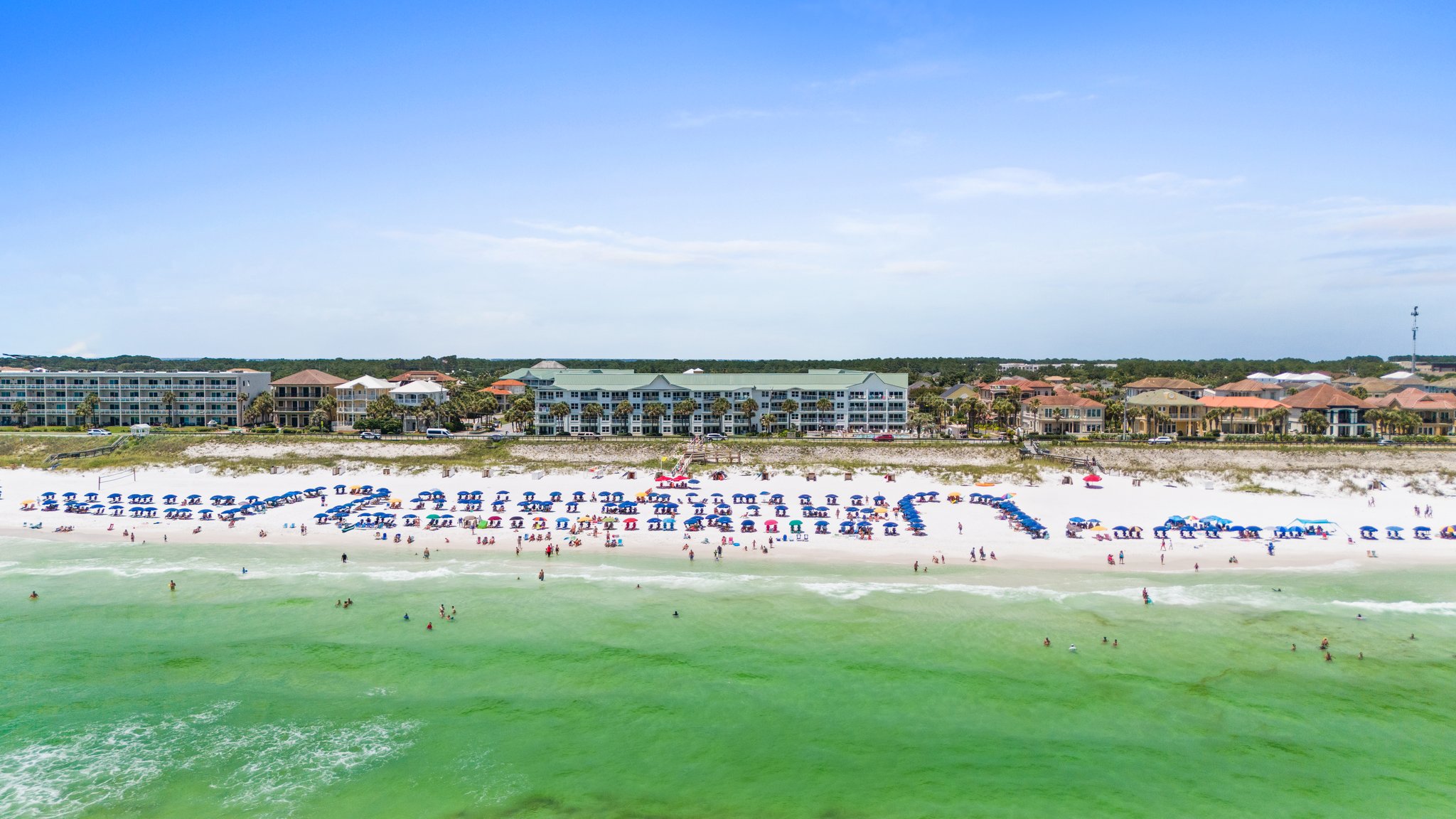 Aerial view of Maravilla Beach Resort in Miramar Beach, Florida from the Gulf on a sunny day